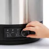A hand is shown adjusting the dial on a control panel of a stainless steel appliance. Produktbild-Vorschau