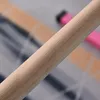 A close-up shot of a wooden bar, with blurred pink and tan objects in the background. Produktbild-Vorschau