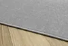 A close-up view of a gray rug with a textured surface, lying on a wooden floor. Náhled obrázku produktu
