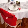 A Christmas-themed table setting with a chair covered by a Santa hat-shaped cover. Produktbild-Vorschau