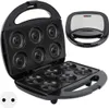 An opened donut maker machine with its top lid open, revealing the donut molds in both the top and bottom plates. The machine is black and sits on a white background. Náhled obrázku produktu