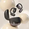 A pair of black wireless earbuds with a charging case are displayed against a backdrop of large, smooth, cream-colored spheres. Náhled obrázku produktu
