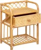 A rattan nightstand with a drawer and a lower shelf, presented against a white background. Voir les images du produit