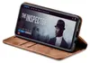 A smartphone in a brown flip case is displayed on a white background, showing a movie playing on the screen. Produktbild-Vorschau