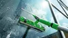 A window cleaning tool is being used to clean a large glass window, with soap suds and reflections of the sky visible. Produktbild-Vorschau