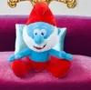 A plush toy of Papa Smurf sitting on a pink sofa with a light blue pillow behind him. Produktbild-Vorschau