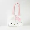 A white Hello Kitty plush tote bag with pink handles and a pink bow. Voir les images du produit
