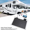 A solar panel charger and controller are shown in the foreground, with a row of RVs in the background. Podgląd zdjęcia produktu