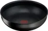 A black wok or frying pan is shown from a slightly elevated angle against a white background. Podgląd zdjęcia produktu