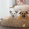 Two dogs are lying on a fluffy dog bed in a home setting. Produktbild-Vorschau