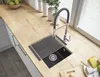 A modern kitchen countertop with a sink, faucet, and a roll-up drying rack. Podgląd zdjęcia produktu