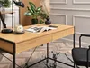 A modern desk setup with a wooden top and black metal legs, featuring a lamp, a mug, a magazine, and a vase with dried flowers. Náhled obrázku produktu