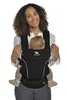A woman is holding a baby in a black baby carrier. Produktbild-Vorschau