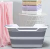 A collapsible pet bathtub is shown in a bathroom setting with towels and a basket. Produktbild-Vorschau