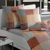 The image shows bedding and pillows on a sofa, suggesting a cozy and comfortable setting. Produktbild-Vorschau