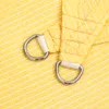 Close-up of two D-rings attached to a yellow fabric. Produktbild-Vorschau
