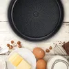 A baking pan and ingredients for baking are arranged on a wooden surface. Voir les images du produit