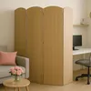 A room divider is placed in a living room area next to a sofa and a desk with a computer. Podgląd zdjęcia produktu