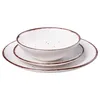 A stack of white ceramic plates and a bowl with a brown rim and speckles. Náhled obrázku produktu