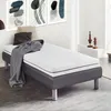 A single bed with a mattress, blanket, and pillows in a room with abstract art on the wall. Produktbild-Vorschau