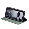 A smartphone case is displayed in a green color, with the phone inside showing a movie poster. Produktbild-Vorschau