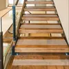 A close-up view of wooden stairs with glass railings. Produktbild-Vorschau