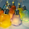 A close-up shot of a string of solar-powered LED lights shaped like tulips in various colors. Produktbild-Vorschau