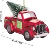 A red glass ornament shaped like a pick-up truck with a Christmas tree in the back, shown against a white background with measurement indicators. Voir les images du produit