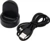 A black charging dock and a black USB cable are shown on a white background. Náhľad obrázku produktu