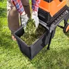 A person is using a garden shredder to shred plant material into a collection bin. Produktbild-Vorschau