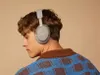 A man wearing headphones, viewed from the back and side. Produktbild-Vorschau