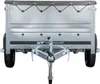 Rear view of a small, silver utility trailer with a dark gray cover and a hitch. Produktbild-Vorschau