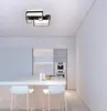 A modern kitchen with white cabinets, a white island with two white bar stools, and a contemporary ceiling light fixture. Produktbild-Vorschau