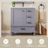 A bathroom vanity cabinet with a sink and drawers, shown in a bathroom setting with a towel rack and laundry basket. Icons and text describing product features are displayed at the bottom. Anteprima dell’immagine prodotto