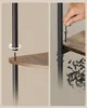 Close-up of someone assembling a corner shelf unit, showing how to attach a shelf to a metal support pole. Produktbild-Vorschau