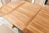 A close-up view of a wooden garden table with slats and an umbrella hole. Produktbild-Vorschau