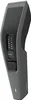A close-up, angled studio shot of a gray and black hair clipper against a white background. Anteprima dell’immagine prodotto