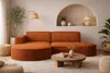 A modern living room with a sectional sofa, coffee table, and decorative elements. Produktbild-Vorschau