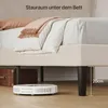 A low-angle shot of a bed frame with a robot vacuum cleaner underneath, highlighting the storage space. Produktbild-Vorschau