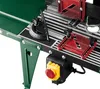 A close-up view of a green and black table saw with red accessories and a yellow emergency stop button. Produktbild-Vorschau