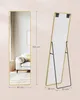 A full-length mirror is shown from the front and back, with dimensions indicated. The front view shows the mirror reflecting a living room scene with a sofa and rug. The back view shows the stand. Produktbild-Vorschau