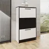 A modern shoe cabinet with three drawers, two white and one black, is shown in a room with a concrete wall and wooden floor. Produktbild-Vorschau