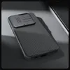 A black phone case with a textured surface and a sliding camera cover is shown on a gray surface. Náhľad obrázku produktu