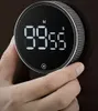 A hand is holding a digital kitchen timer. Podgląd zdjęcia produktu