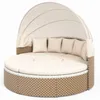 A round outdoor daybed with a canopy and cushions, presented on a white background. Voir les images du produit