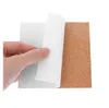 A hand is peeling the white backing off a cork tile. Produktbild-Vorschau