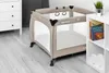 A baby playpen is shown in a room with a dresser and a bookshelf. Produktbild-Vorschau