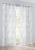 Two white sheer curtains with a circular pattern are hanging in front of a window. Produktbild-Vorschau