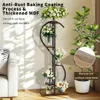 A multi-tiered plant stand with flowers is displayed in a living room setting next to a sofa and a large potted plant. Anteprima dell’immagine prodotto