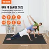 Three people are doing exercises on a large black mat in a room with white blinds. Náhled obrázku produktu